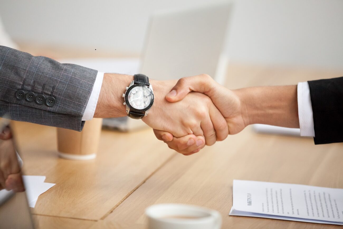 Closeup view of handshake, two businessmen in suits shaking hand