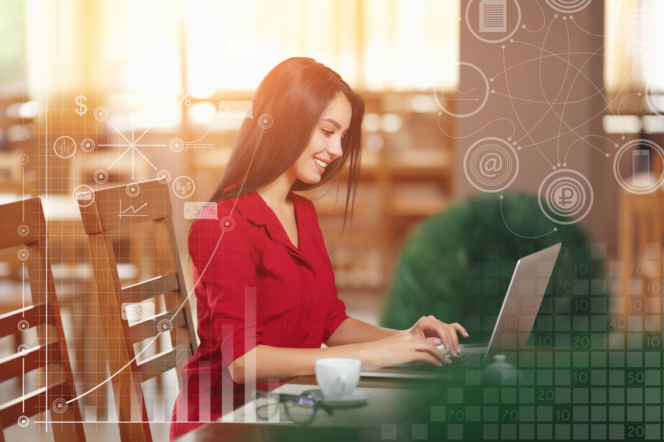 Young business woman uses laptop in cafe